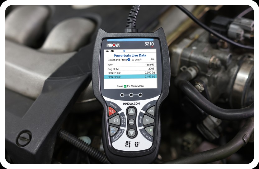 Image of Innova OBD2 scanner being used on a car