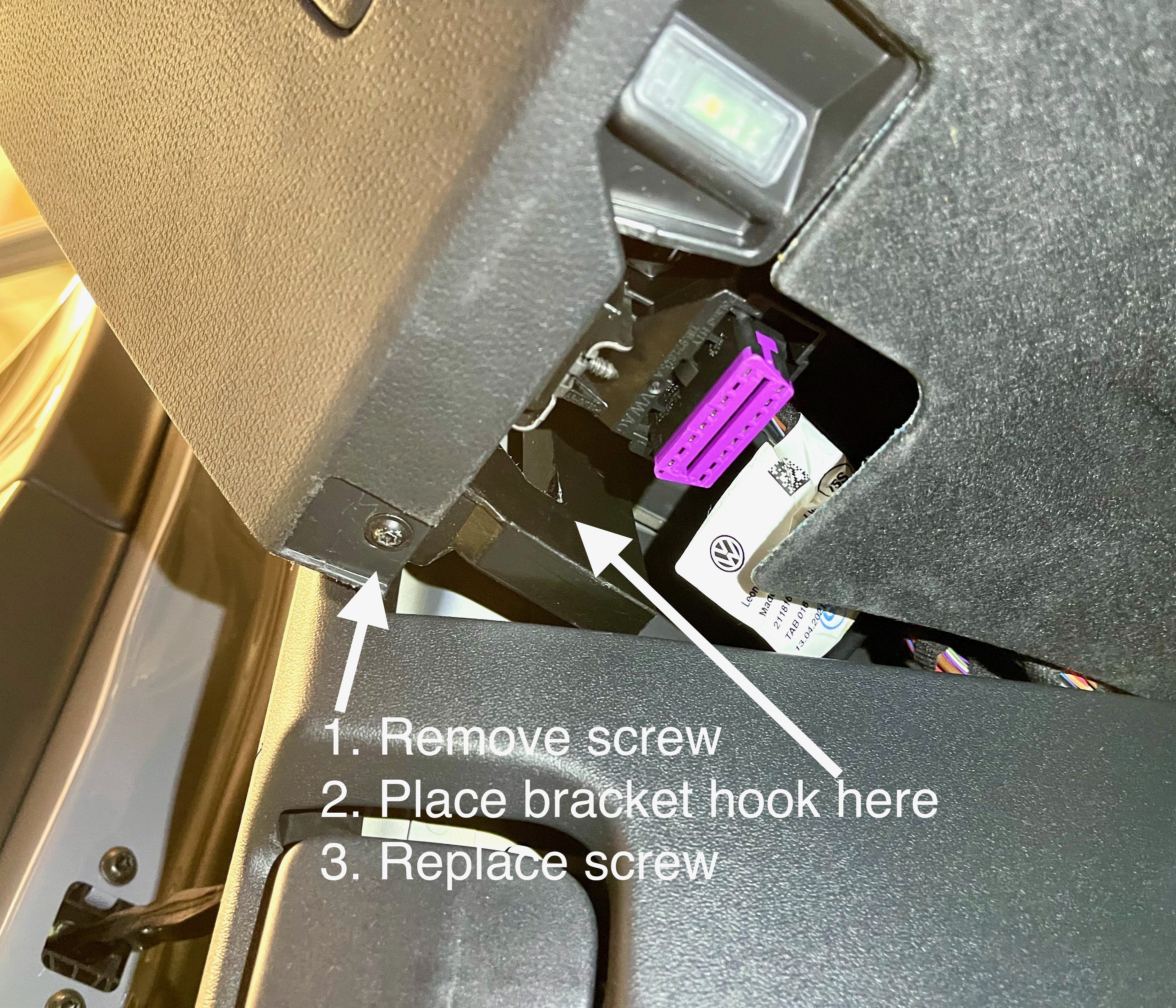 Secure mounting brace location under the dashboard of a VW ID.4 for OBD2 bracket installation.