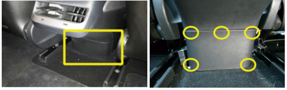 Prying open the rear center console panel of a 2020 Tesla Model 3 to access the OBD2 port location using an Allen wrench.