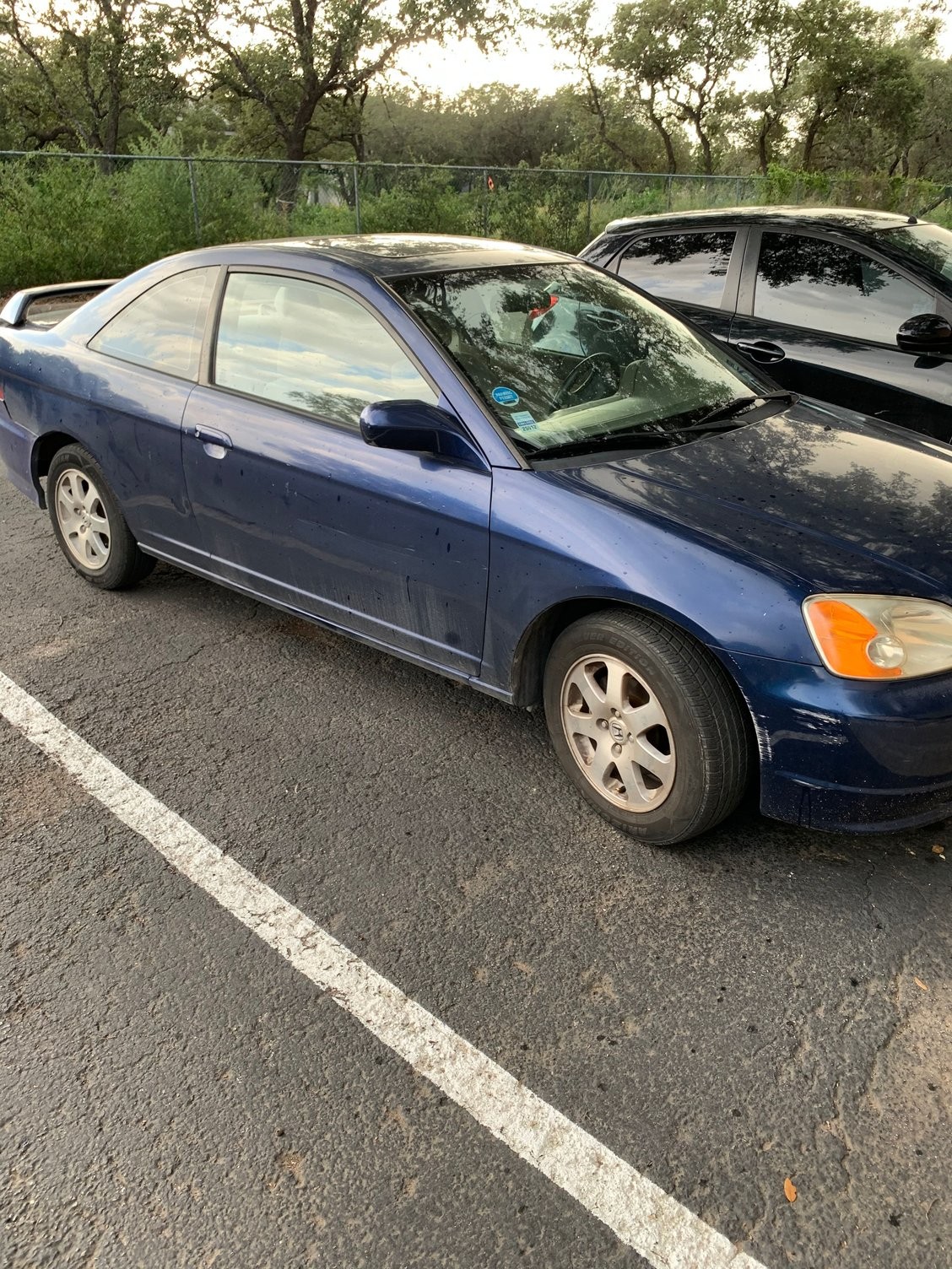 Close-up of a red 2003 Honda Civic EX Coupe, a popular car model where owners often need to locate the OBD2 port for diagnostics.