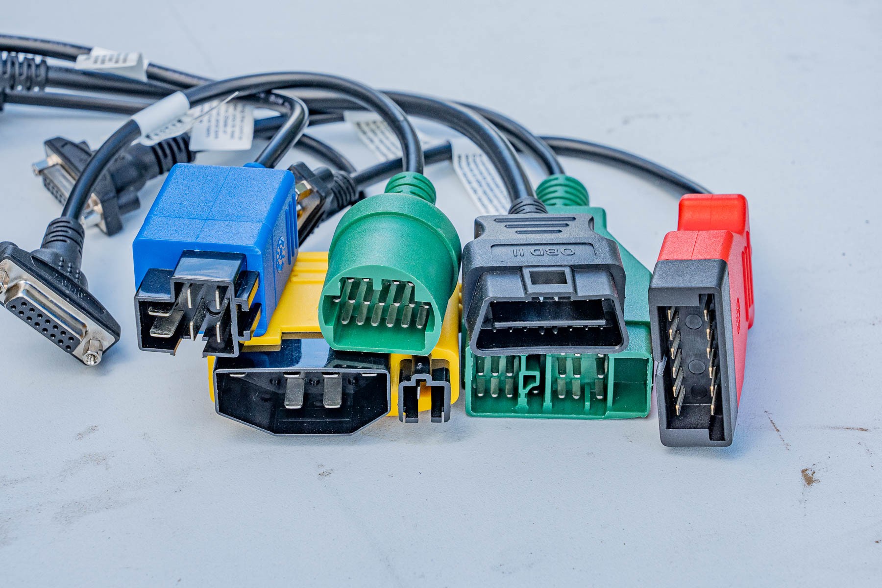 A collection of OBD2 scanner wire connectors, highlighting the Bosch 1300 OBD's extensive compatibility