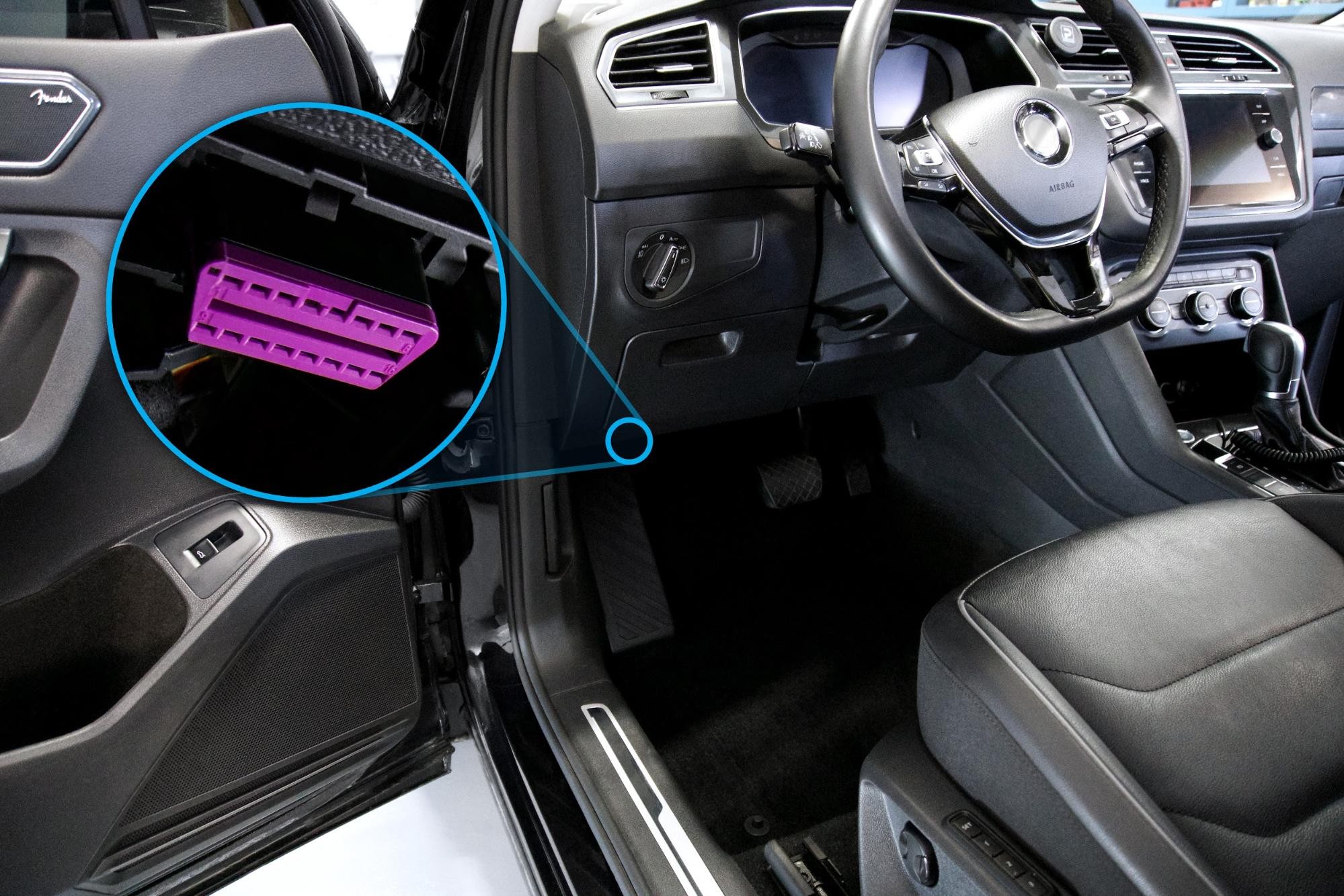 Diagram showing the location of the OBDII port under the dashboard of a vehicle