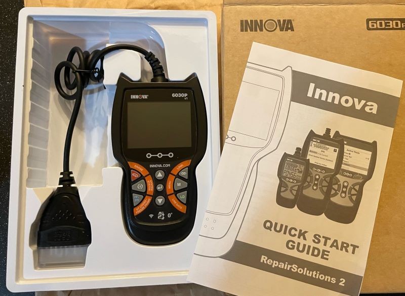 Innova 6030P OBD2 Scanner: A close-up view of the handheld car diagnostic tool.