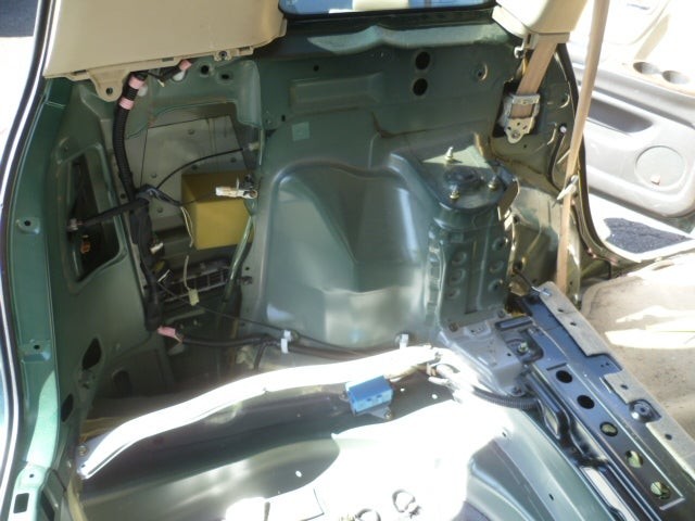 View from rear hatch showing interior access for wheel speed sensor on Toyota