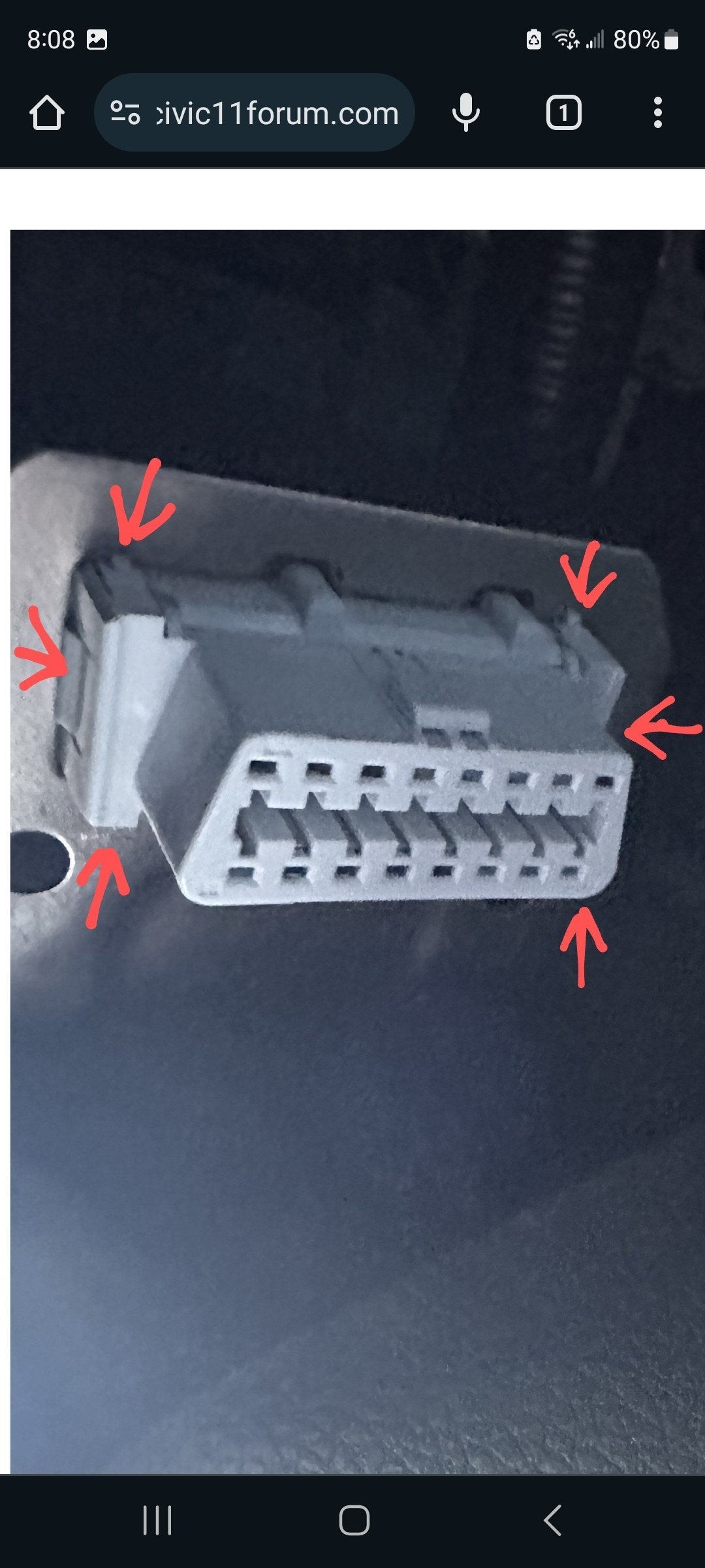 Close-up view highlighting the retaining clips on the OBD2 port connector